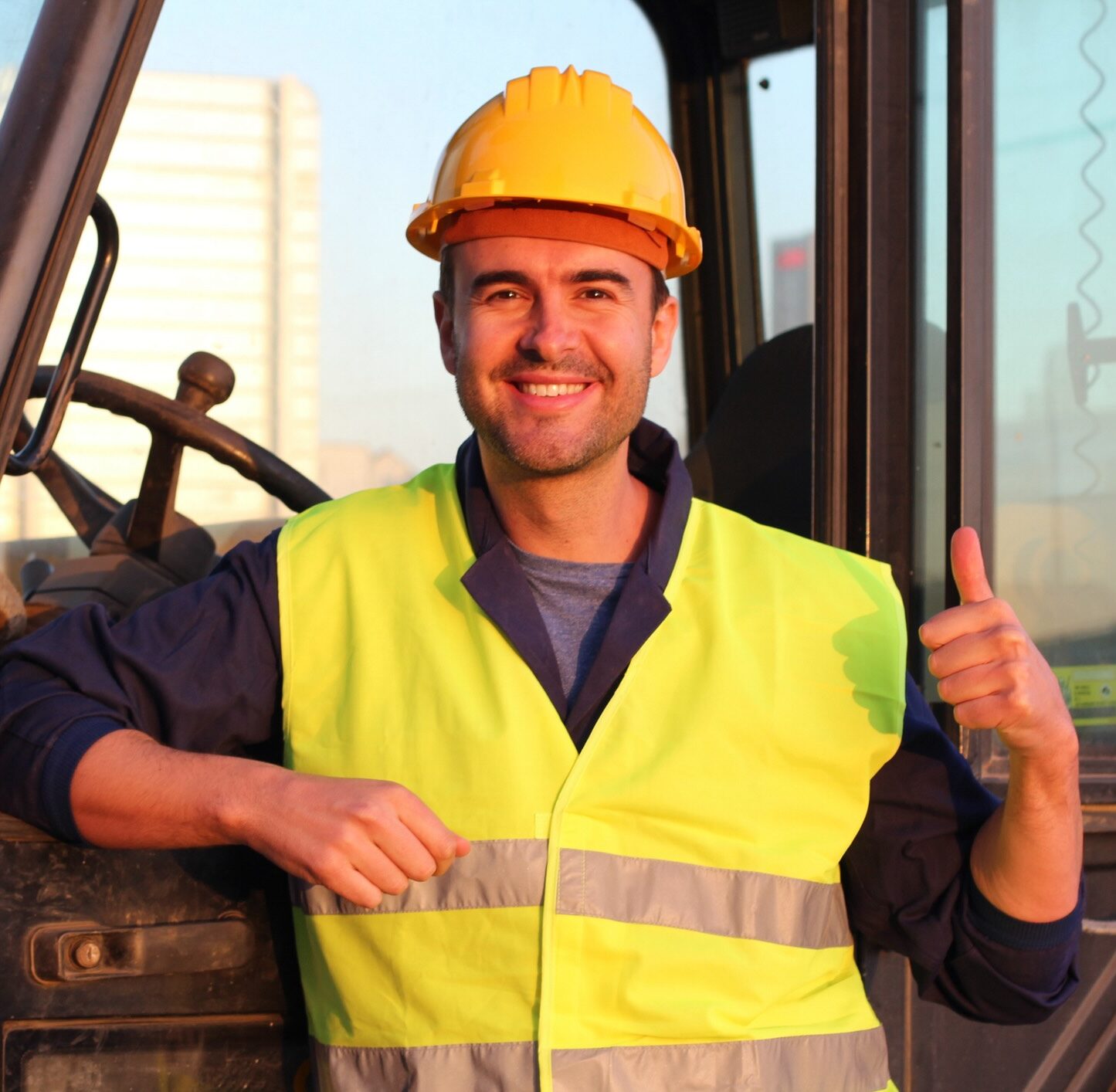 Professional construction industry driver giving thumbs up.