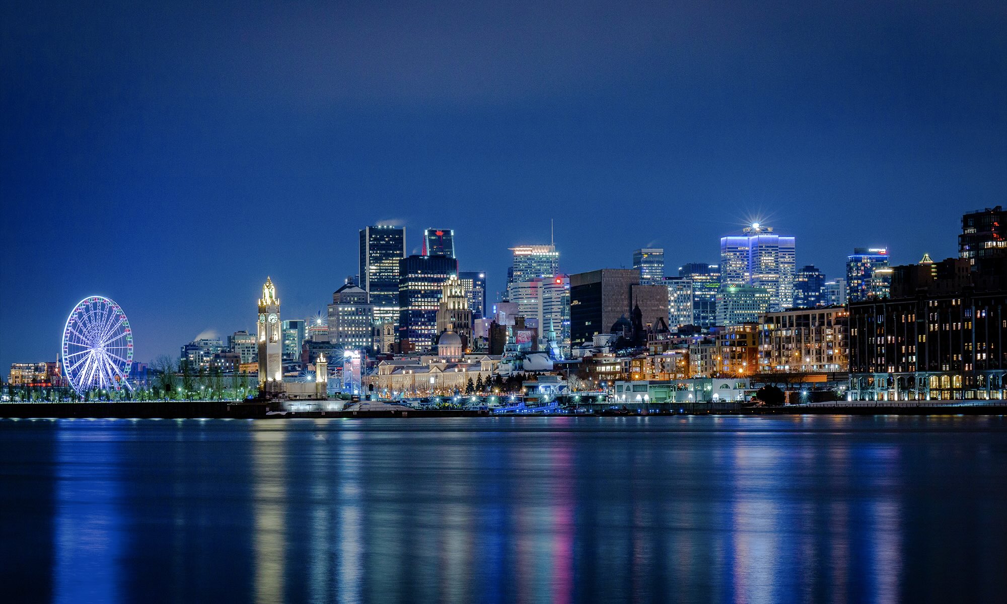 City of Montreal from the water at night with the skyline lit up.