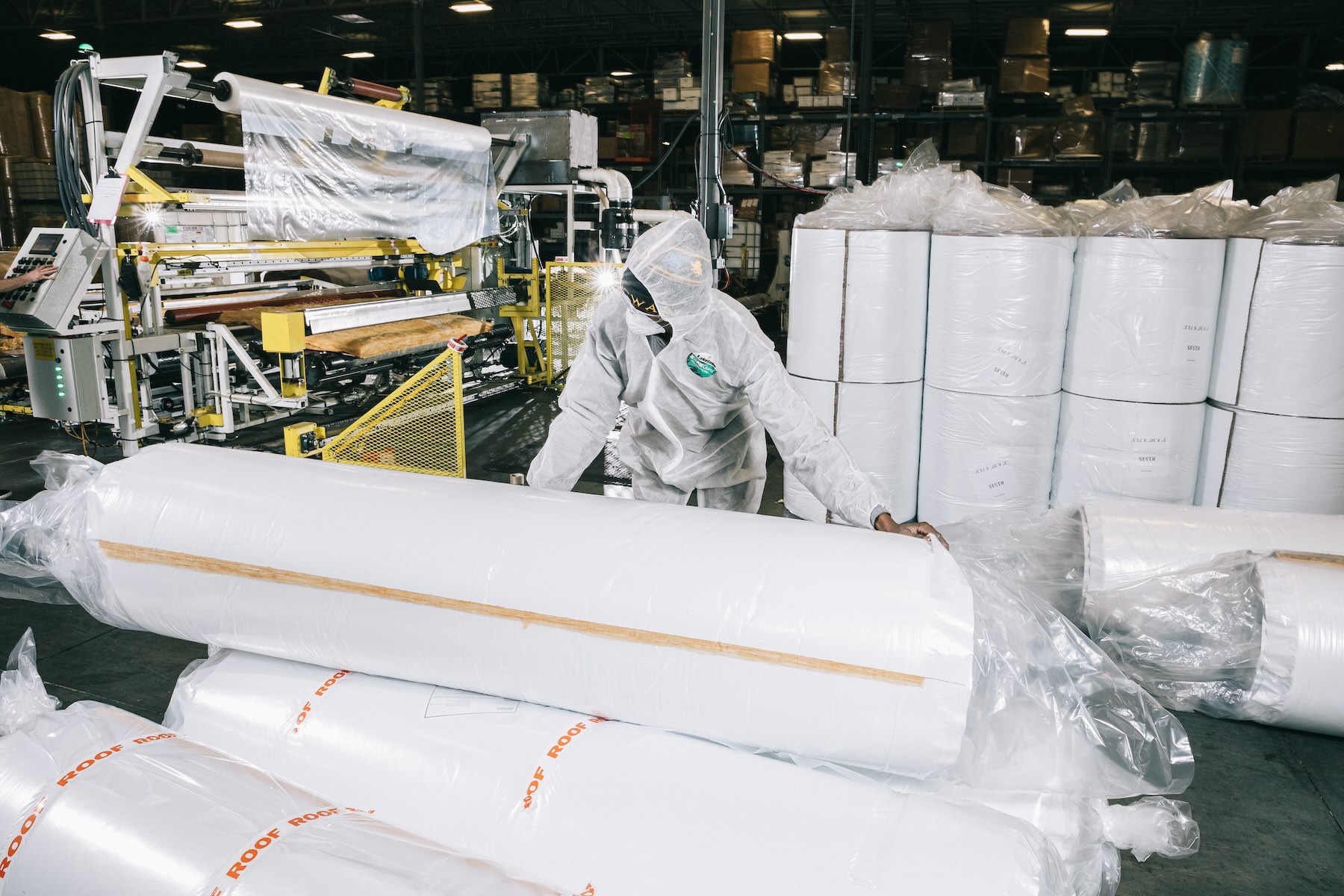 workers fabricating rolls of insulation